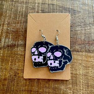 Pink goth skull earrings.